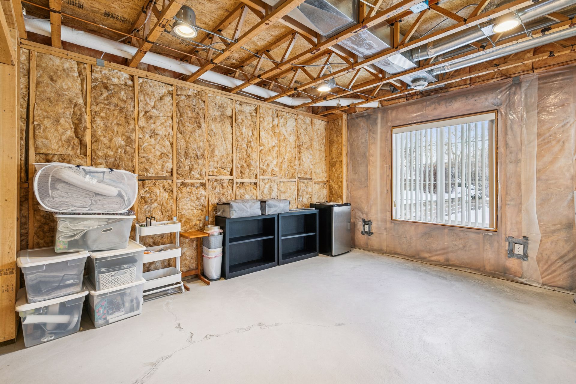 Unfinished lower level provides additional space ready for a second bedroom, and bathroom